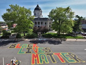 This is a photograph of a "Black Lives Matter" mural painted on 6th Street in downtown Bloomington next to the Monroe County courthouse. The view is to the south from above the street—the shot was taken from the roof of a building on the north side of 6th Street.